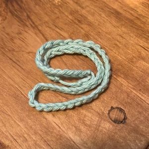 This is a necklace it’s a light blue and it’s tiny